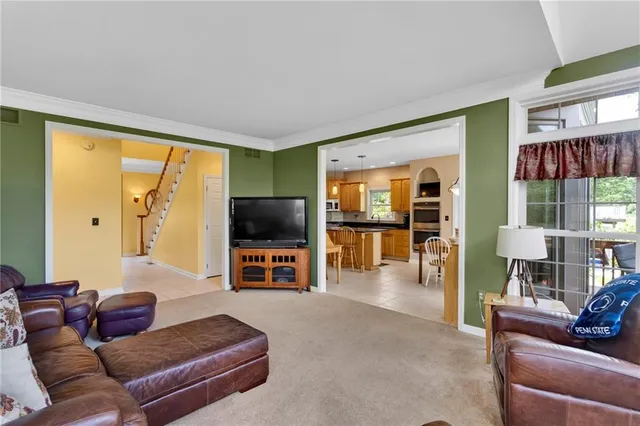 a kitchen with stainless steel appliances granite countertop a sink refrigerator stove and microwave