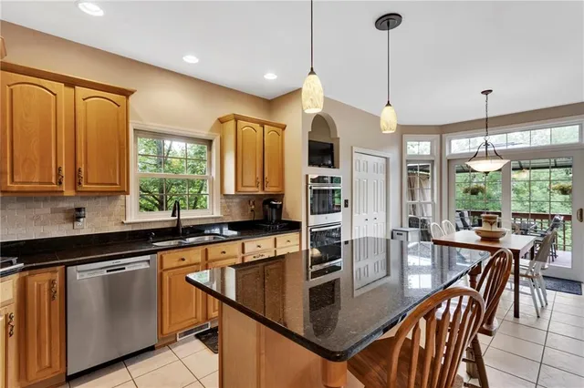 a dining room with furniture a chandelier and wooden floor