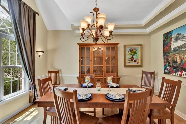 a living room with furniture fireplace and a large window