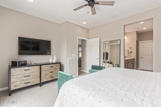 a bedroom with a bed and a flat screen tv in it