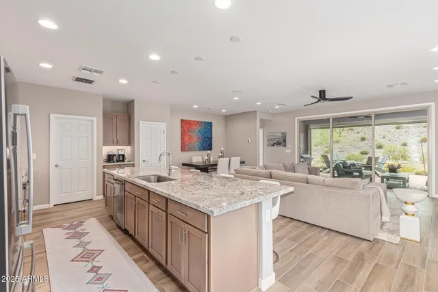 a view of a kitchen counter top space with stainless steel appliances granite countertop furniture and a large window
