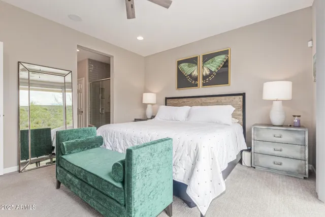 a bedroom with a bed and a painting on the wall