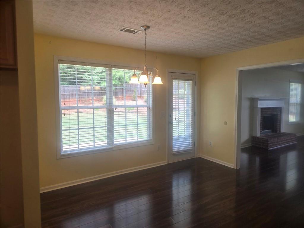 22 Windcrest Keep Covington, GA 30016 - Photo 13 of 32 a view of an empty room with wooden floor and a window