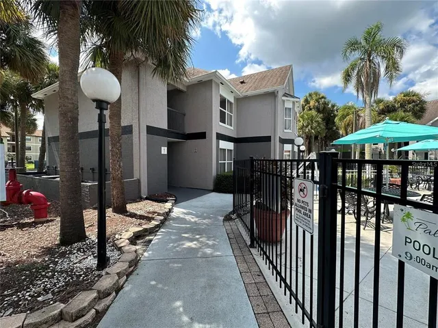 a view of a house with backyard and patio