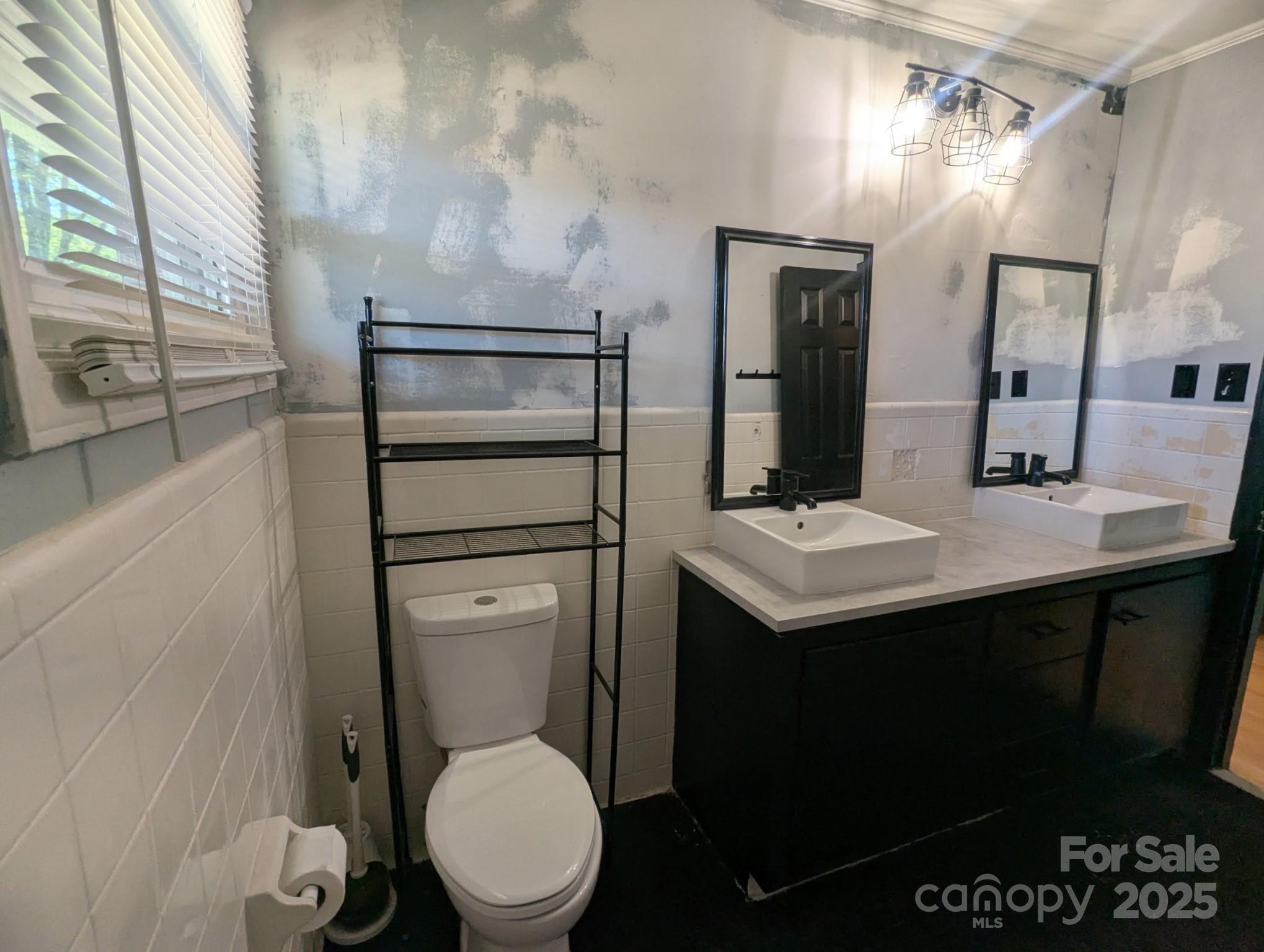 805 Mark Drive Shelby, NC 28152 - Photo 9 of 12 a bathroom with a toilet sink and mirror