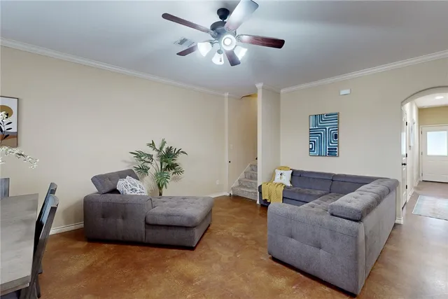a living room with furniture and a potted plant