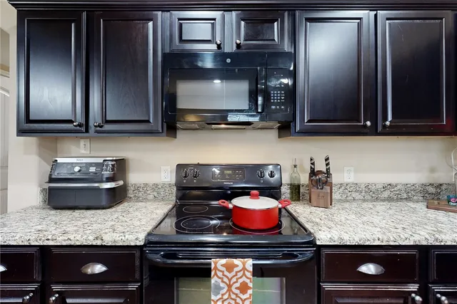 a kitchen with granite countertop stainless steel appliances and cabinets
