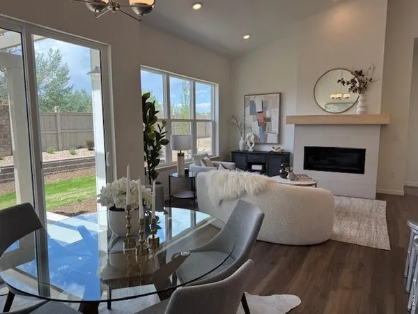a kitchen with a table chairs and a fireplace