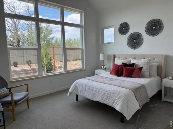 a living room with furniture a large window and a fireplace