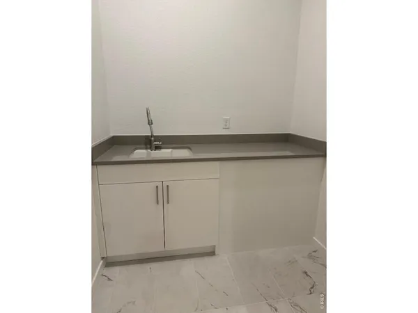 a hallway with wooden floor and door