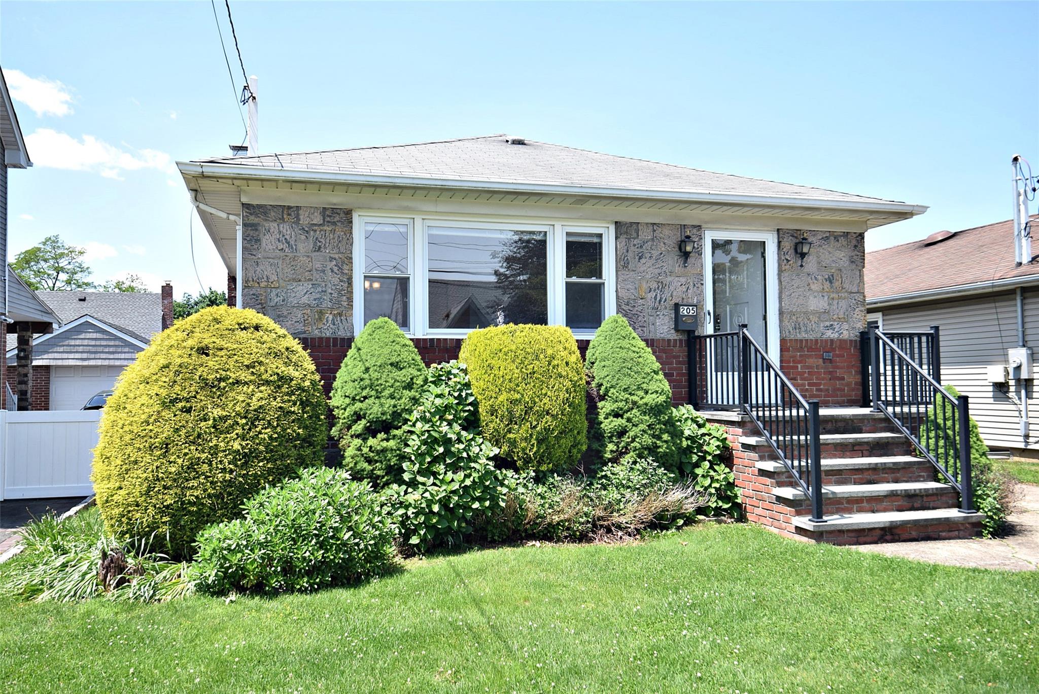 205 White Road Mineola, NY 11501 - Photo 1 of 1 a front view of a house with a yard