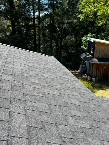 a backyard of a house with fountain table and chairs