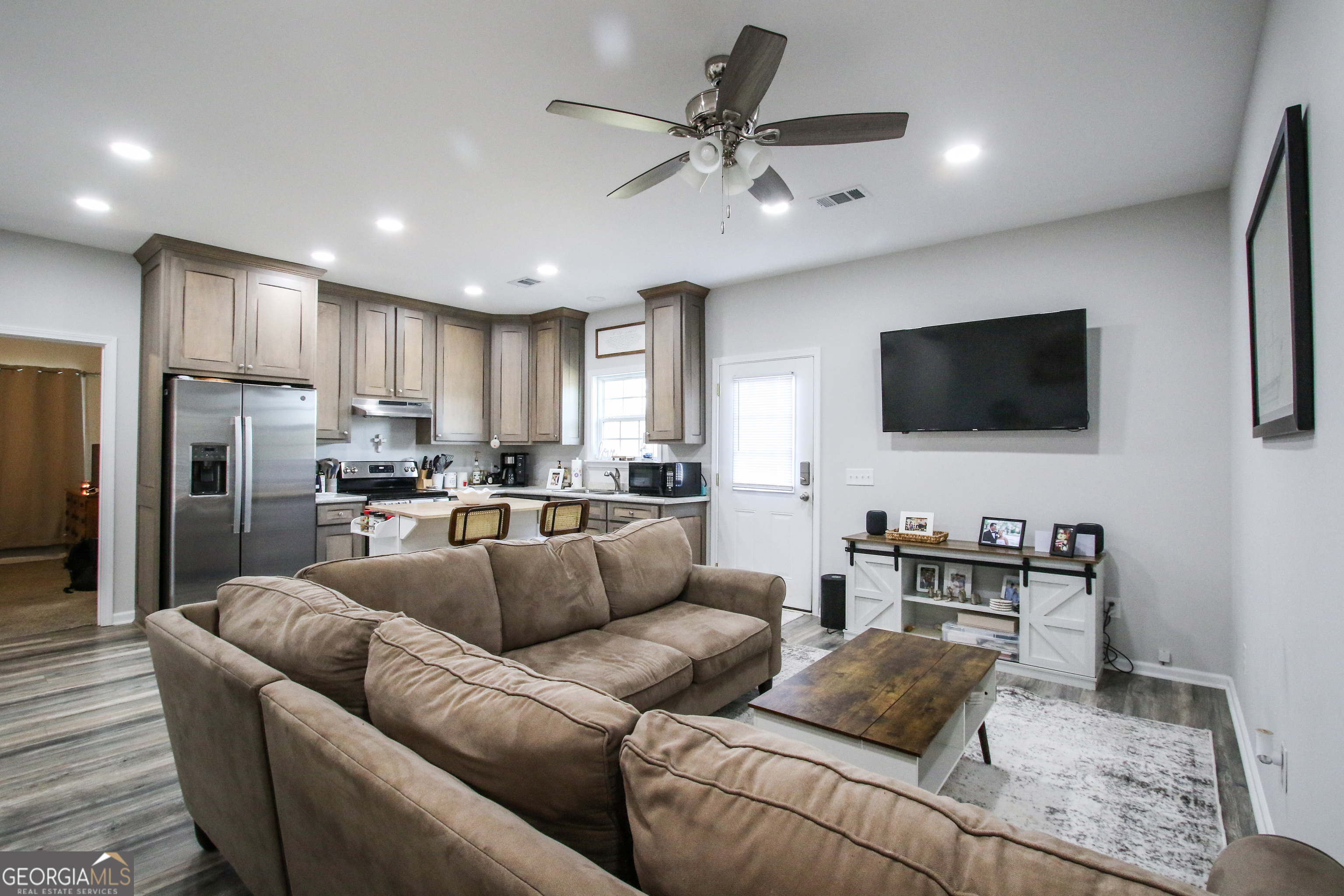11769 Henry Street Collins, GA 30421 - Photo 15 of 51 a living room with furniture and a flat screen tv