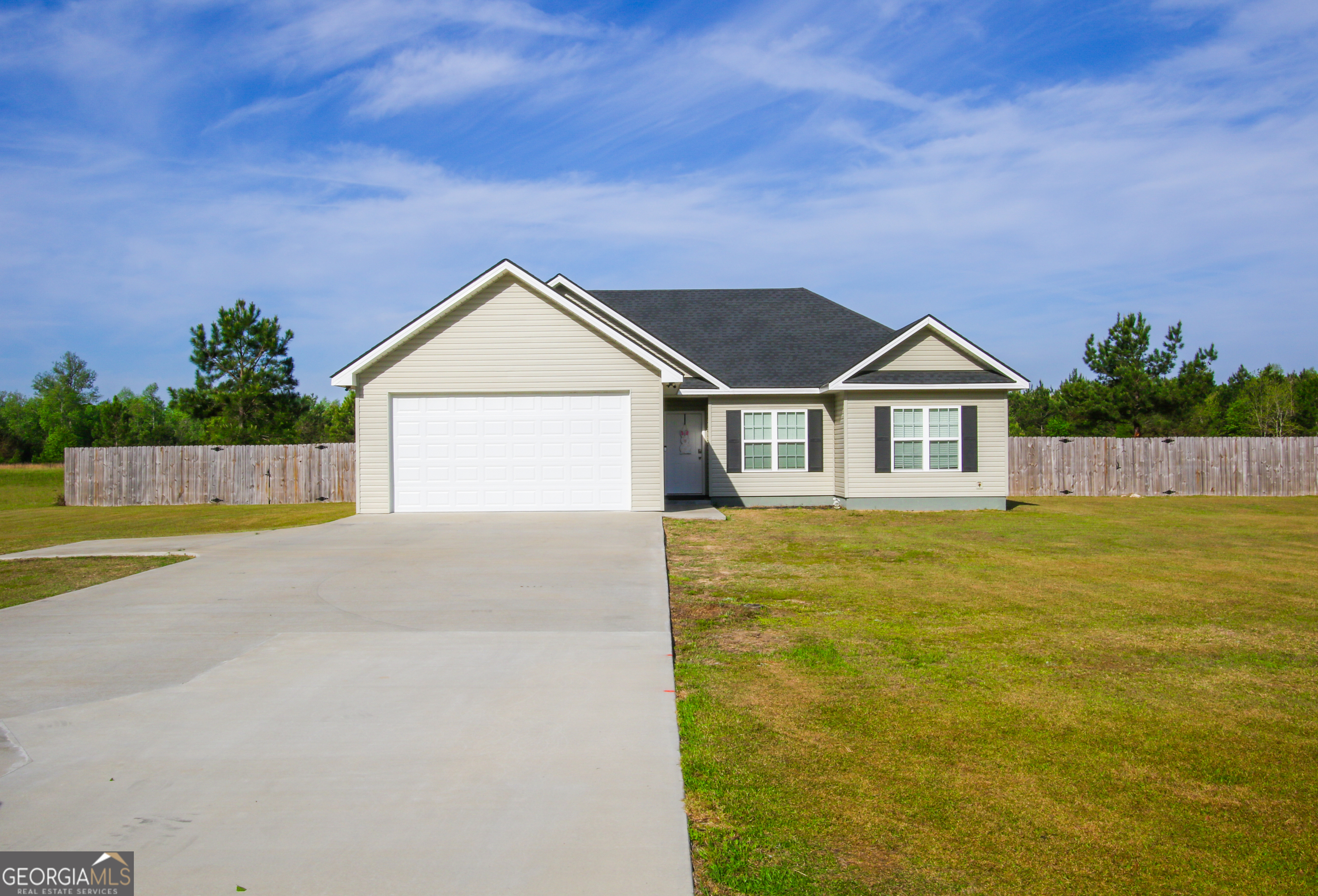 11769 Henry Street Collins, GA 30421 - Photo 2 of 51 a front view of a house with a yard
