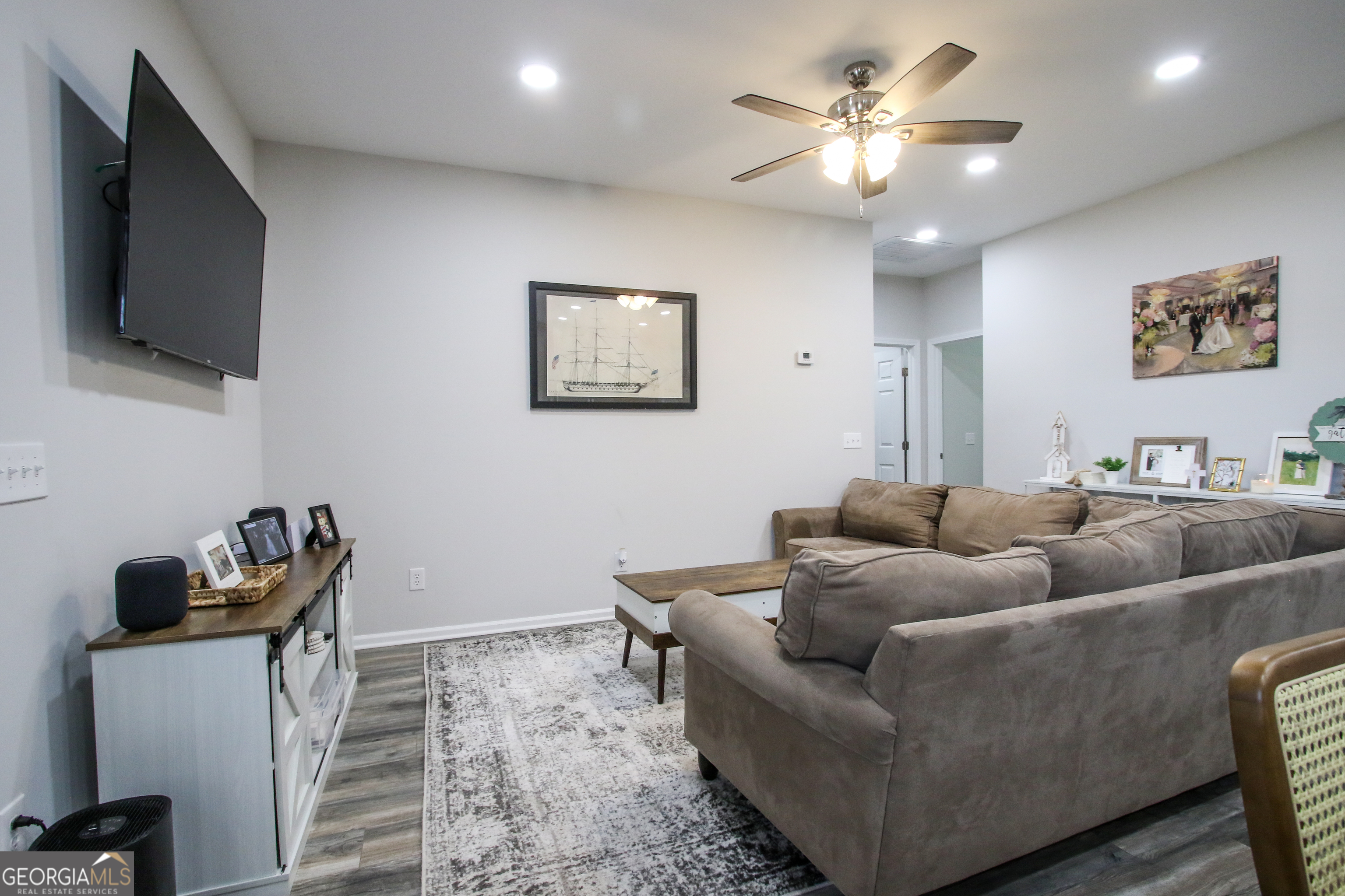 11769 Henry Street Collins, GA 30421 - Photo 21 of 51 a living room with furniture and a flat screen tv