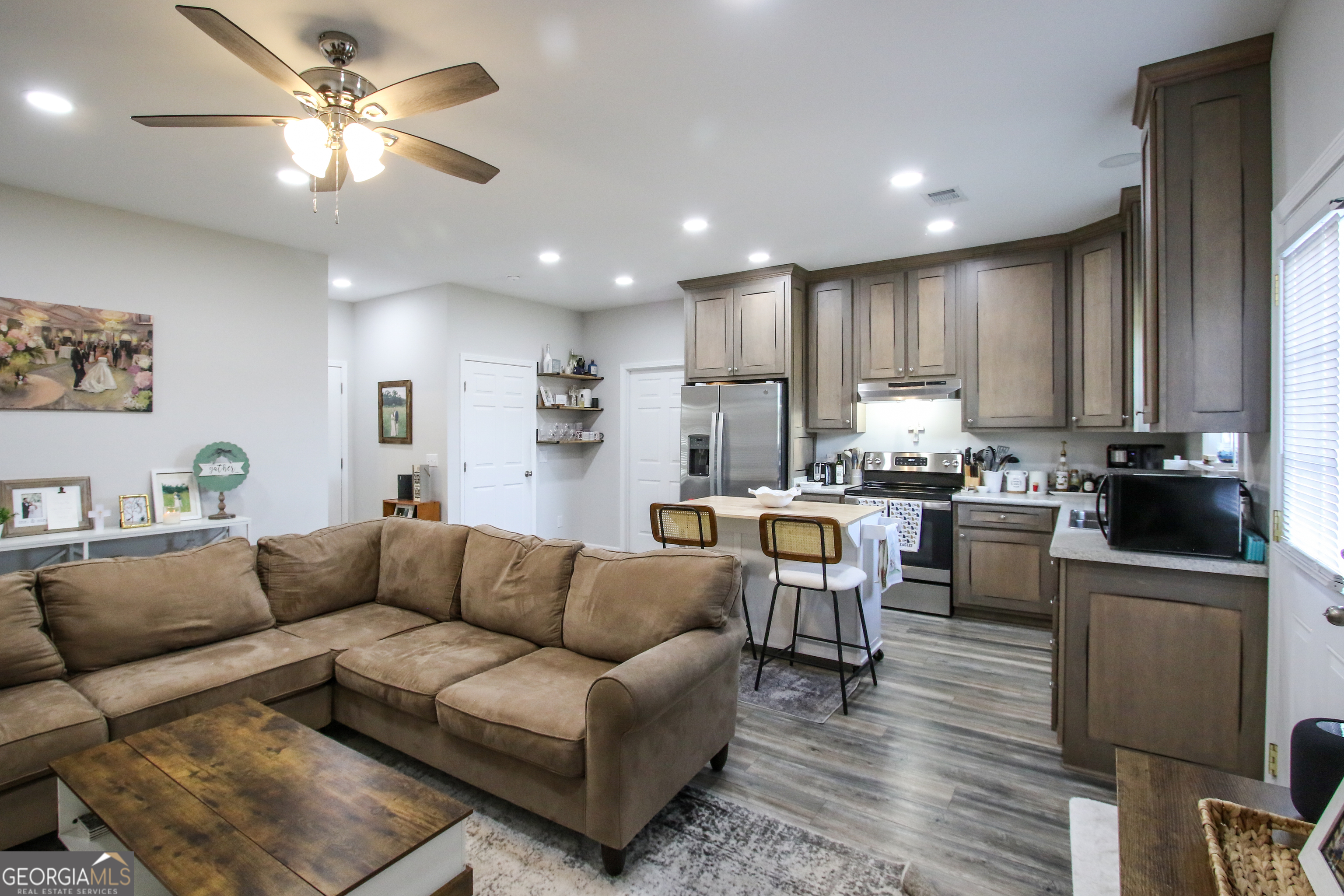 11769 Henry Street Collins, GA 30421 - Photo 23 of 51 a living room with furniture and kitchen view