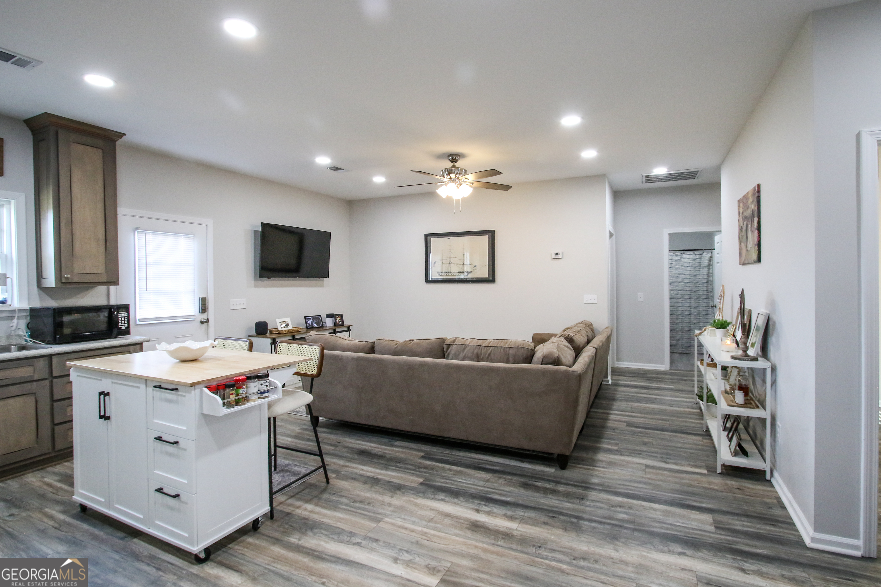 11769 Henry Street Collins, GA 30421 - Photo 25 of 51 a living room with furniture and a flat screen tv
