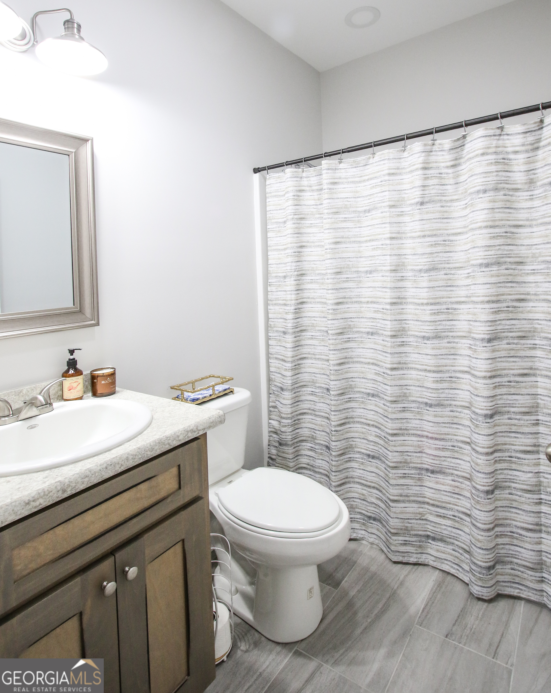 11769 Henry Street Collins, GA 30421 - Photo 26 of 51 a bathroom with a sink a toilet and a mirror