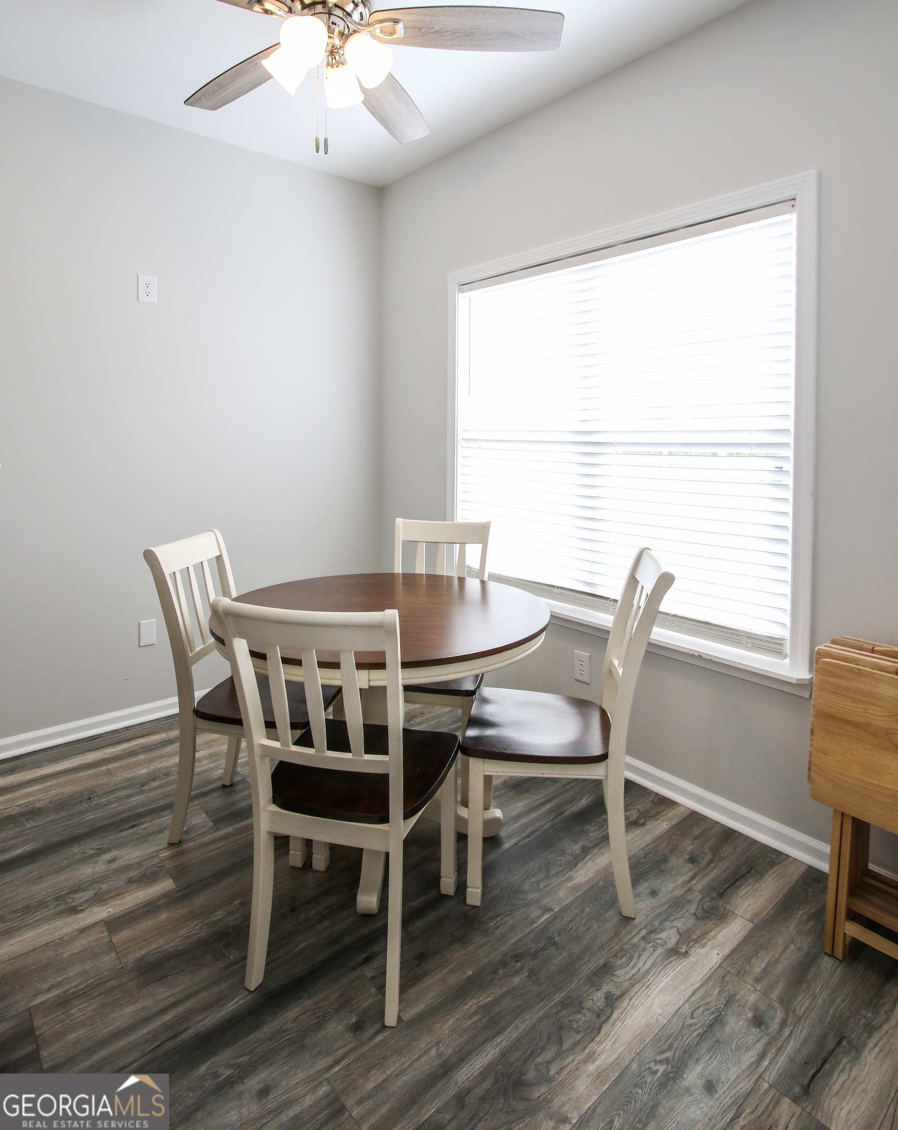 11769 Henry Street Collins, GA 30421 - Photo 28 of 51 a view of a dining room with furniture window and wooden floor