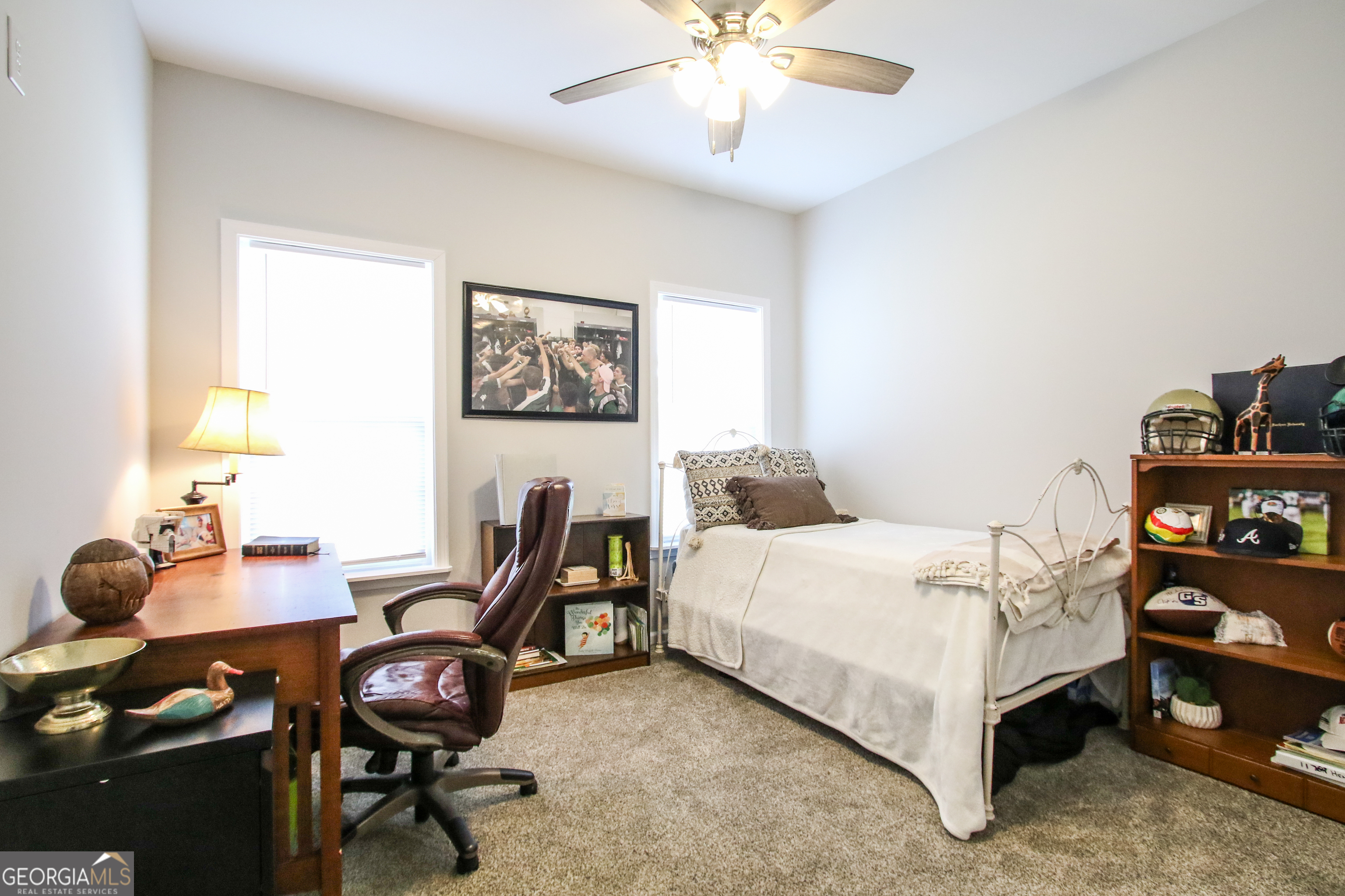11769 Henry Street Collins, GA 30421 - Photo 32 of 51 a bedroom with a bed and a chandelier