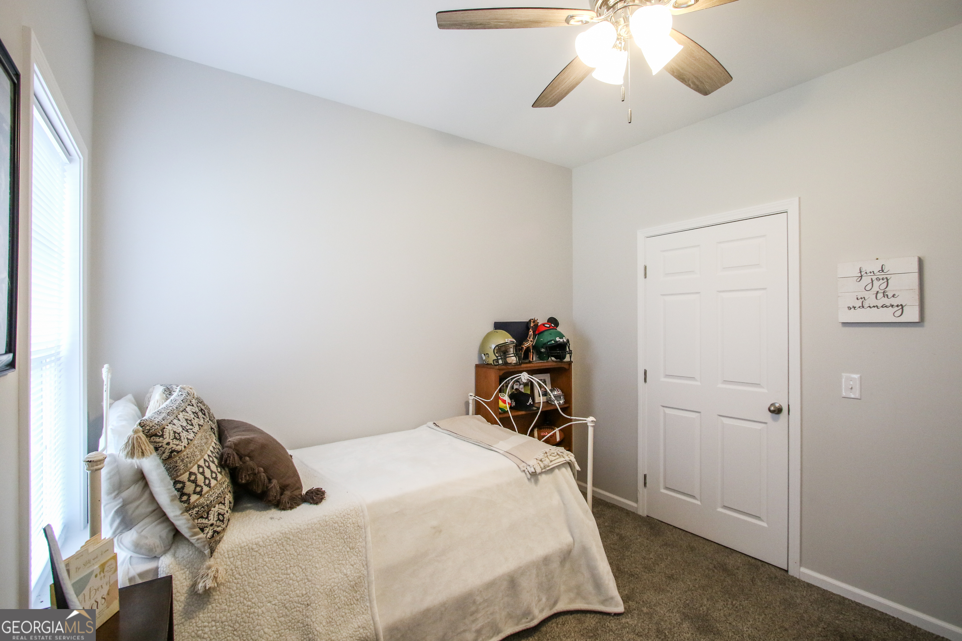 11769 Henry Street Collins, GA 30421 - Photo 34 of 51 a bedroom with a bed and a chandelier