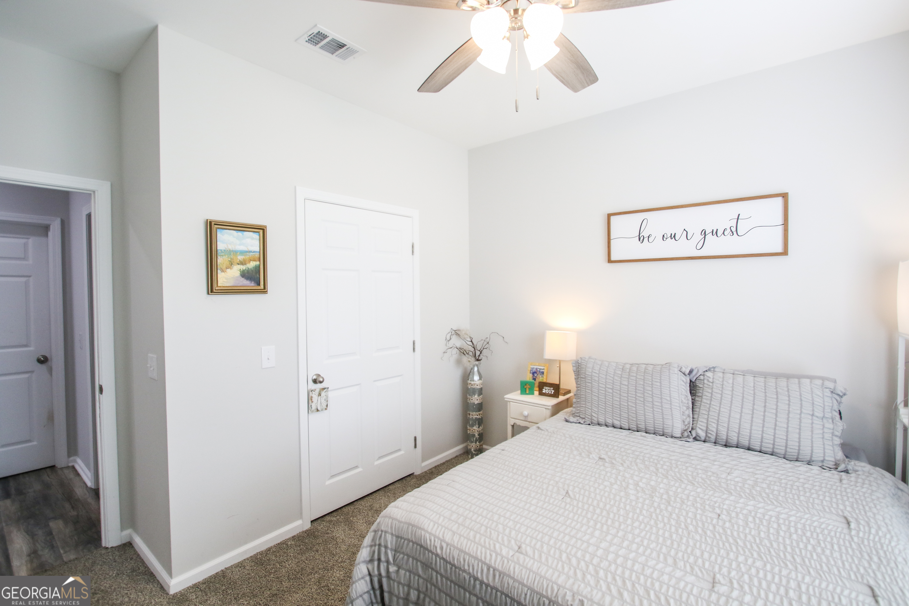 11769 Henry Street Collins, GA 30421 - Photo 36 of 51 a bedroom with a bed and a chandelier