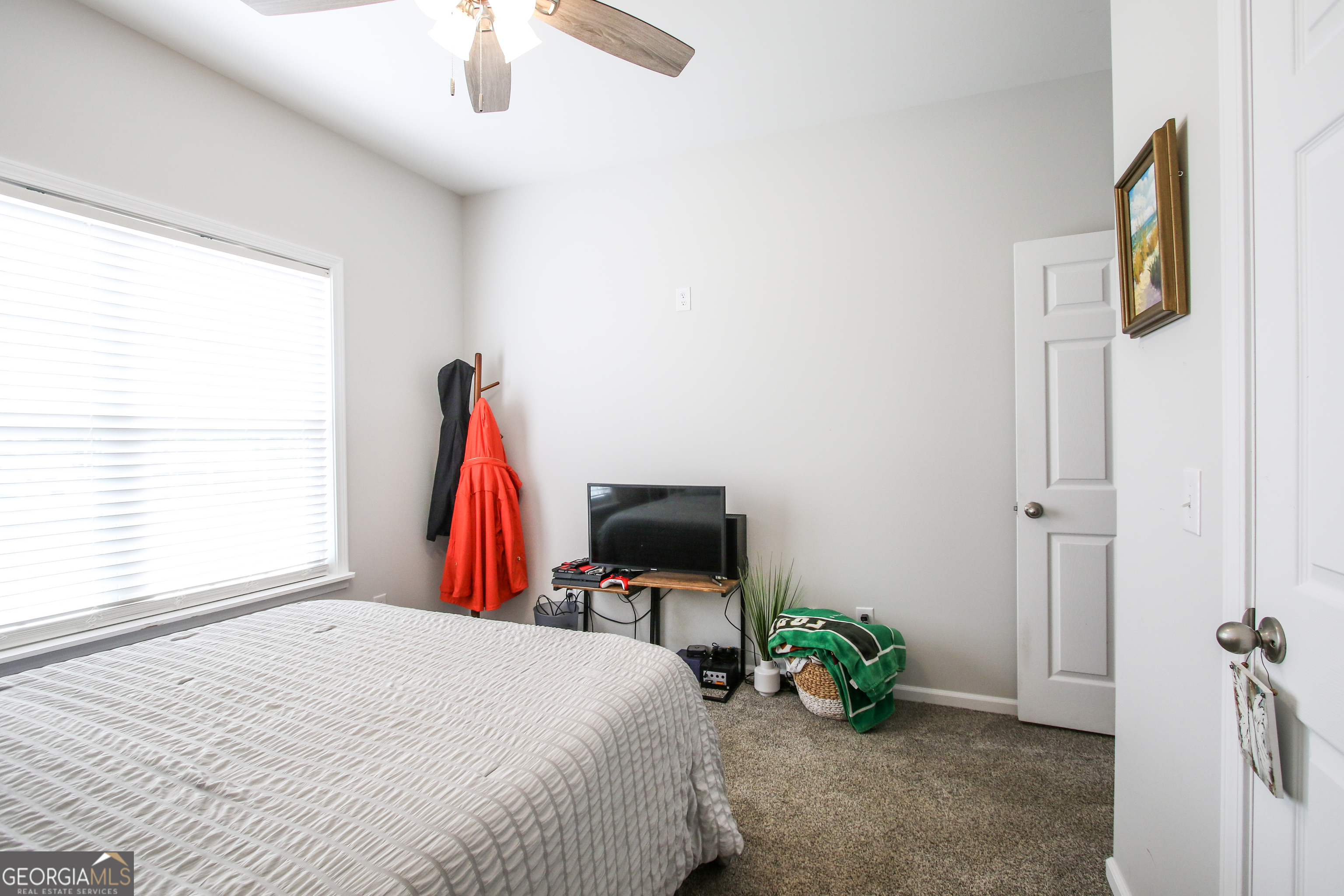 11769 Henry Street Collins, GA 30421 - Photo 37 of 51 a bedroom with a bed and a flat tv screen