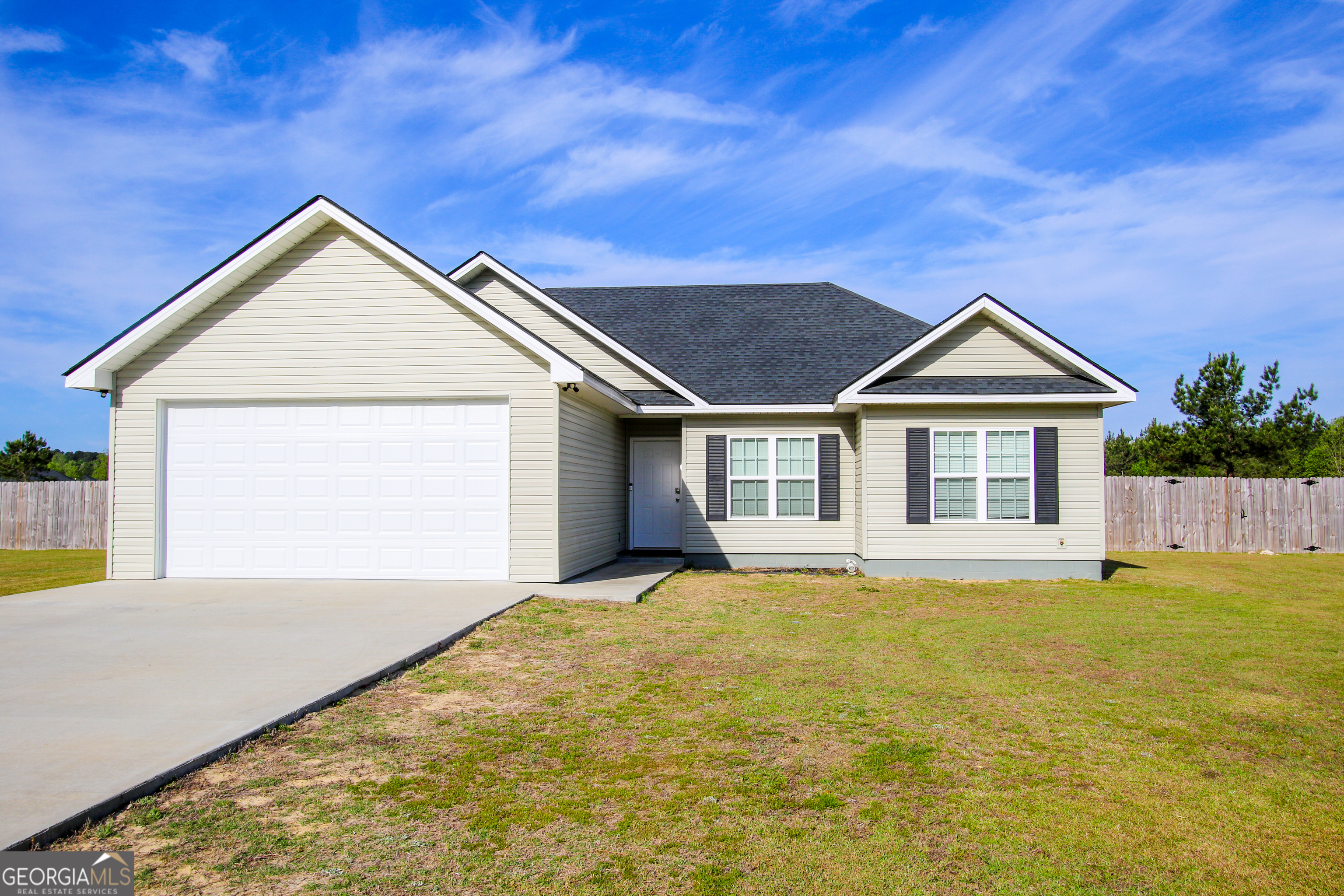 11769 Henry Street Collins, GA 30421 - Photo 4 of 51 a view of a house with a yard and garage