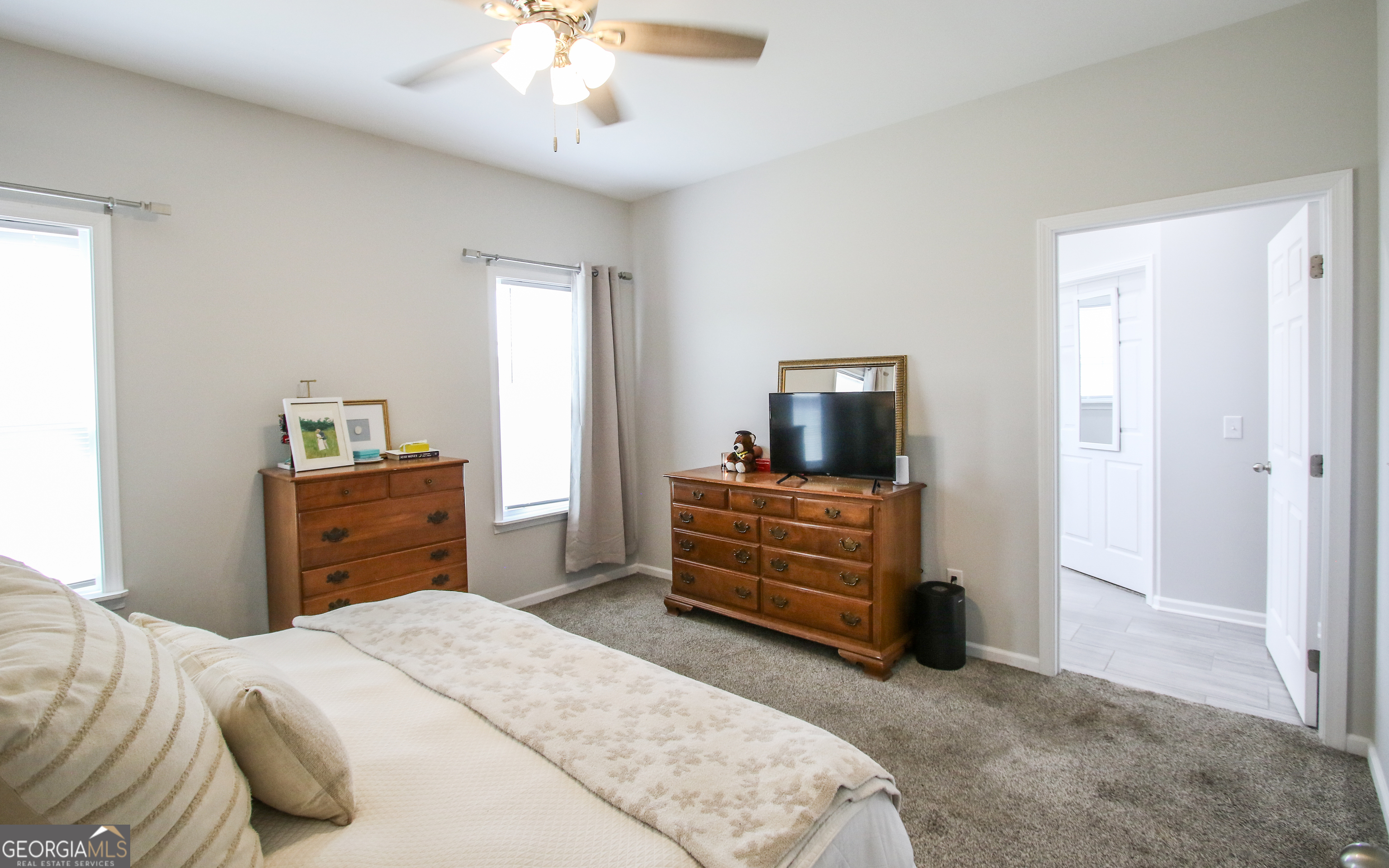 11769 Henry Street Collins, GA 30421 - Photo 46 of 51 a bedroom with a bed and a chandelier