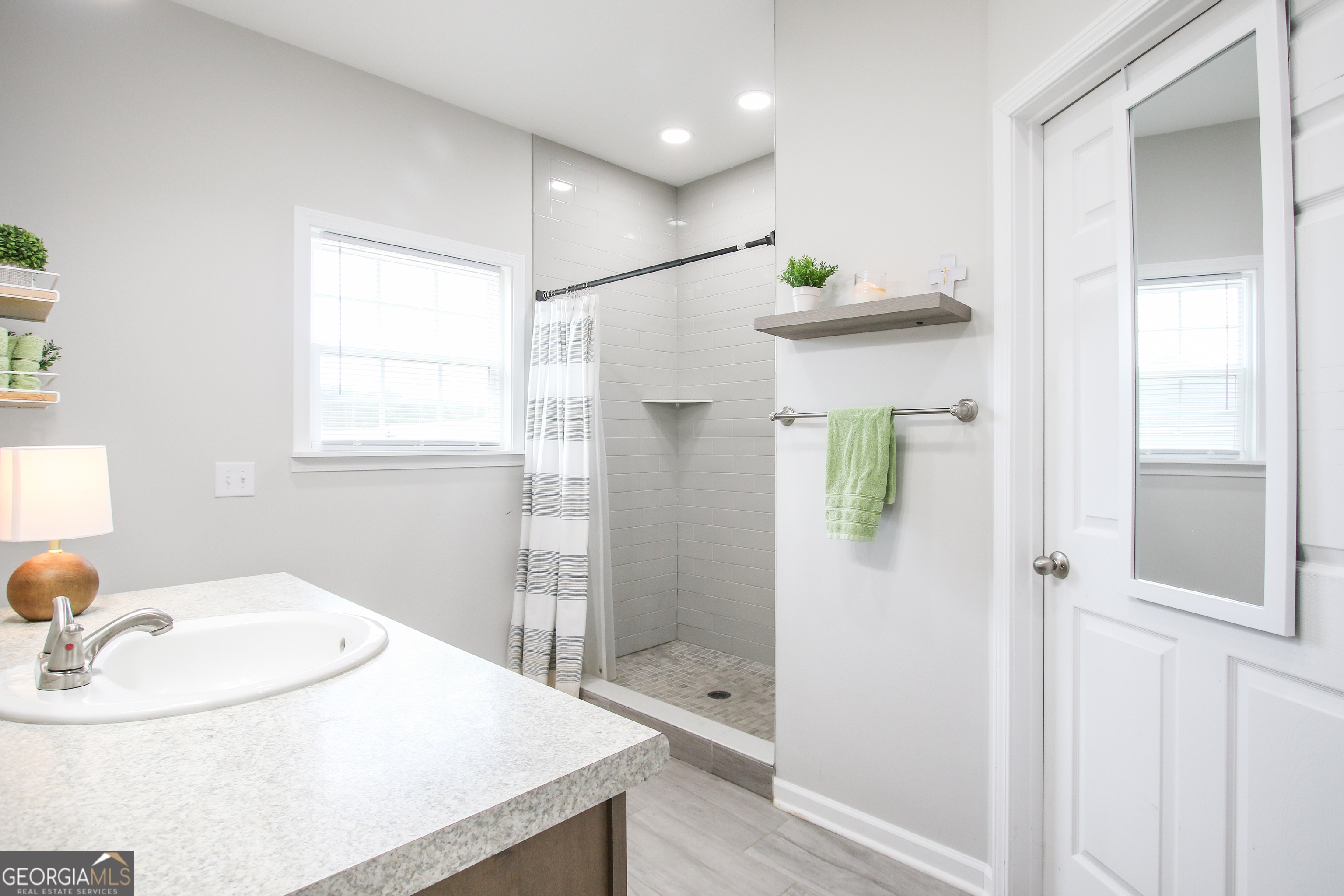 11769 Henry Street Collins, GA 30421 - Photo 47 of 51 a bathroom with a sink and mirror