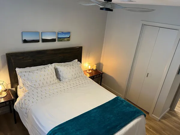 a bed sitting in a bedroom next to a cabinet