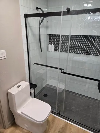 a bathroom with a toilet and a shower