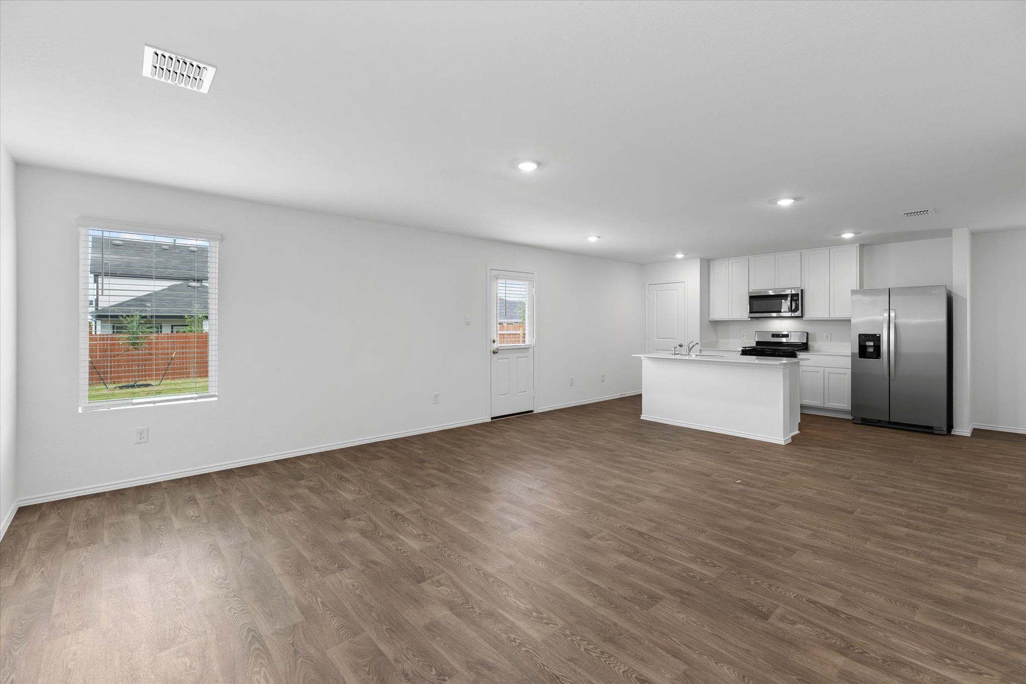 456 Sandringham Loop Kyle, TX 78640 - Photo 26 of 40 A combined living area and kitchen offers modern convenience and versatile living space.