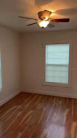 a view of a room with a fan and a window