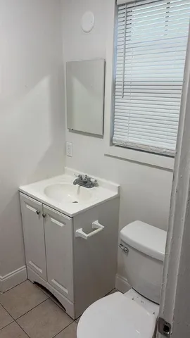 a bathroom with a sink toilet and mirror