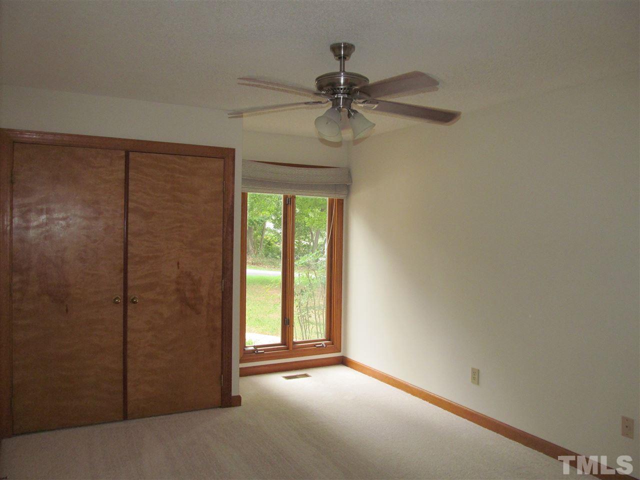 8321 Stryker Court Raleigh, NC 27615 - Photo 11 of 13 an empty room with windows and fan