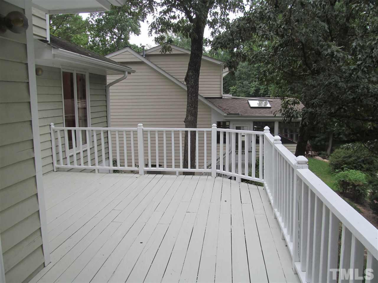 8321 Stryker Court Raleigh, NC 27615 - Photo 12 of 13 a view of deck with wooden floor and fence and trees