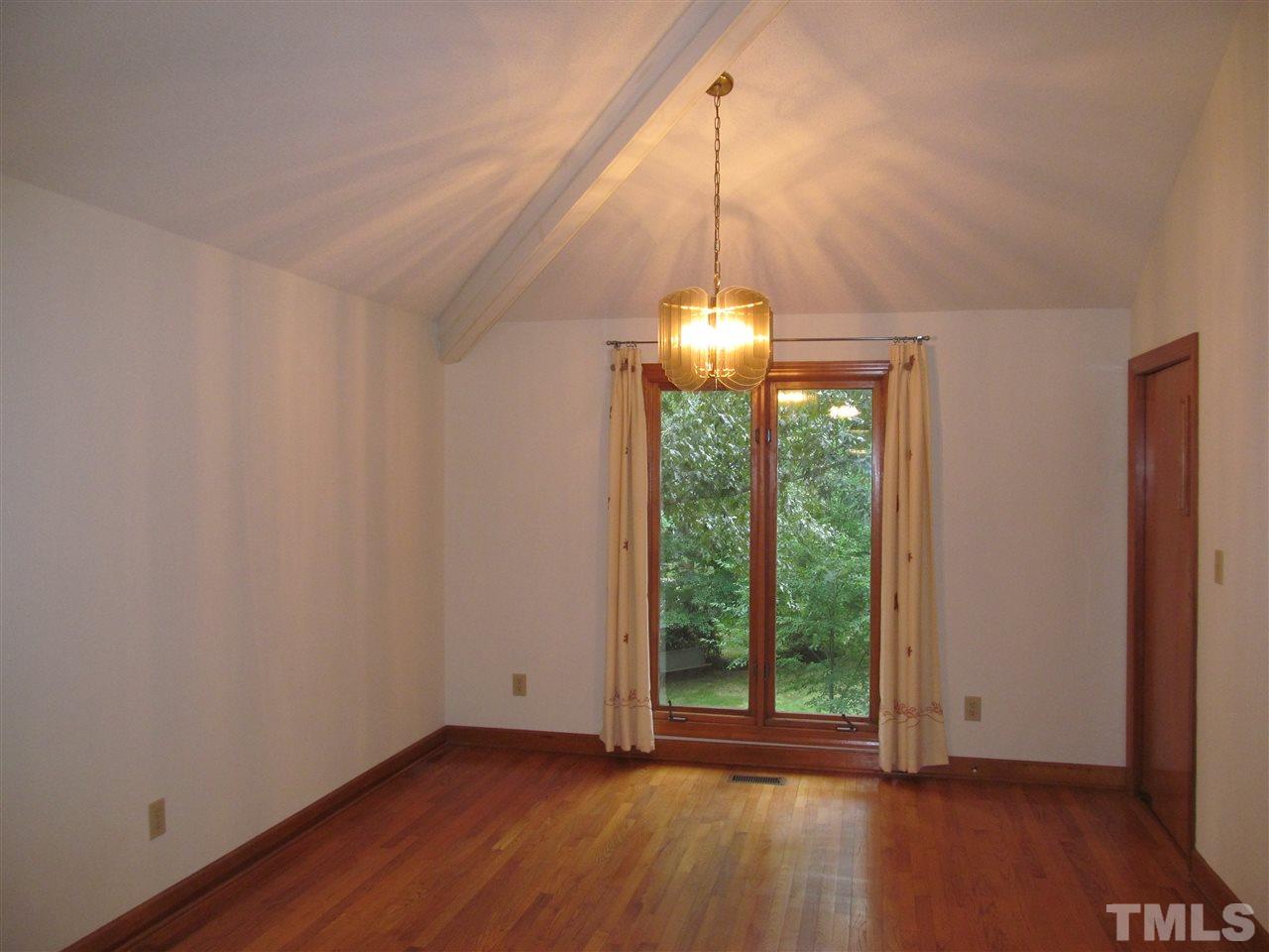 8321 Stryker Court Raleigh, NC 27615 - Photo 3 of 13 a view of a room with wooden floor table and chairs