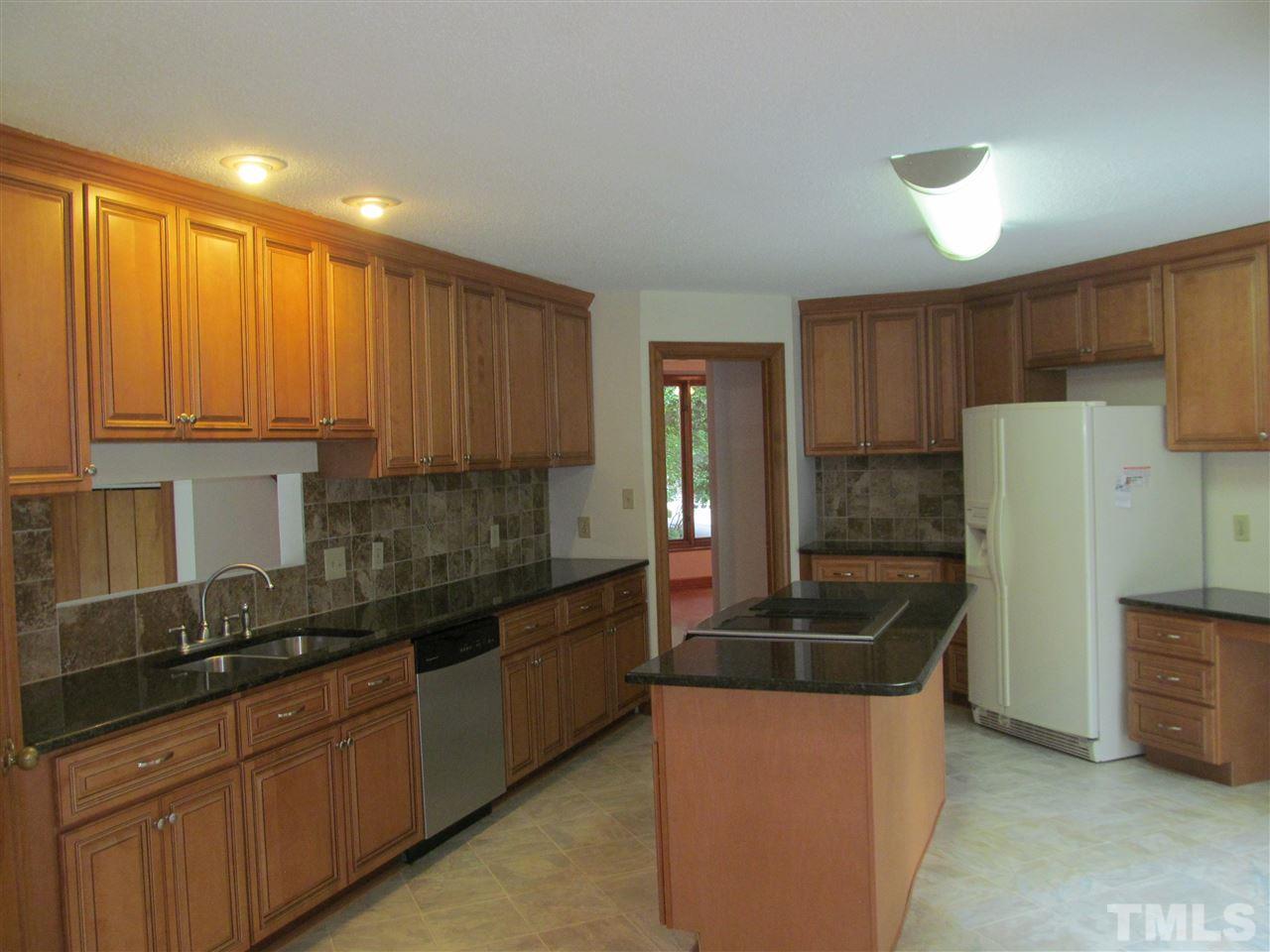 8321 Stryker Court Raleigh, NC 27615 - Photo 4 of 13 a kitchen with granite countertop a sink stainless steel appliances and cabinets
