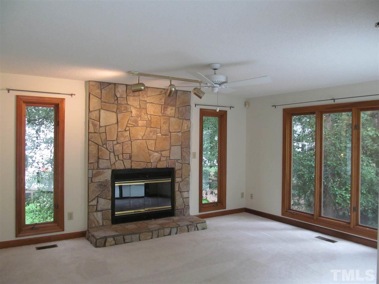 8321 Stryker Court Raleigh, NC 27615 - Photo 6 of 13 a view of an empty room with fireplace and a window