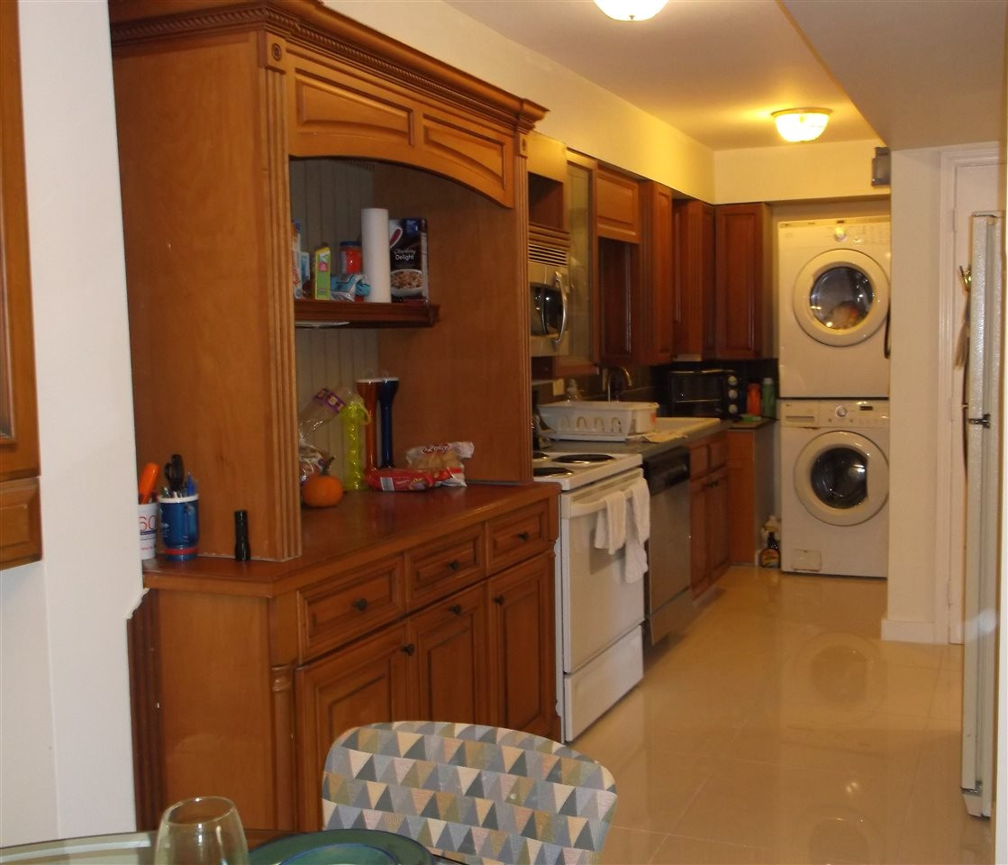 5004 Flint Ridge Place, Unit 5004 Raleigh, NC 27609 - Photo 5 of 12 a kitchen with a refrigerator and a stove top oven