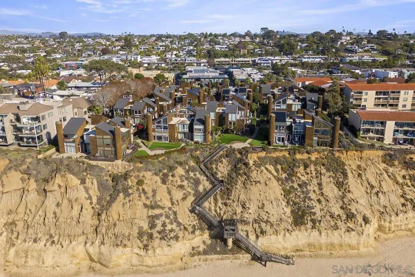 an aerial view of residential houses with city view