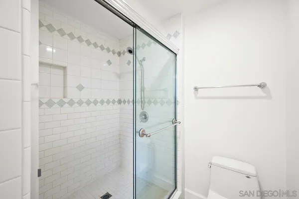 a bathroom with a shower and a toilet