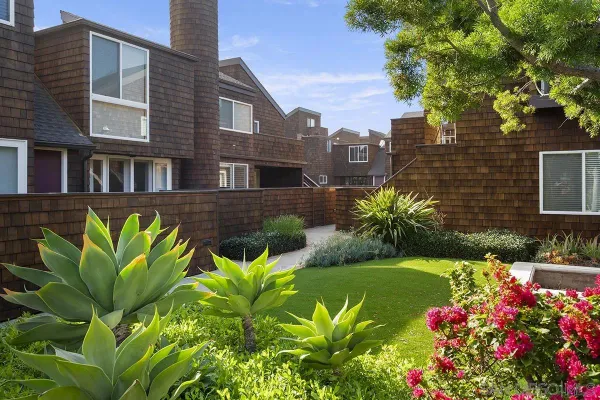 a view of a bunch of flowers in front of house