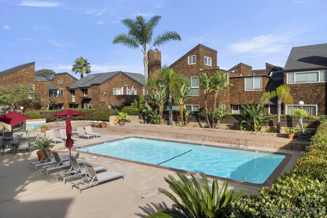 an aerial view of residential houses with city view
