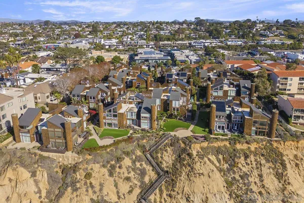 an aerial view of residential houses with city view
