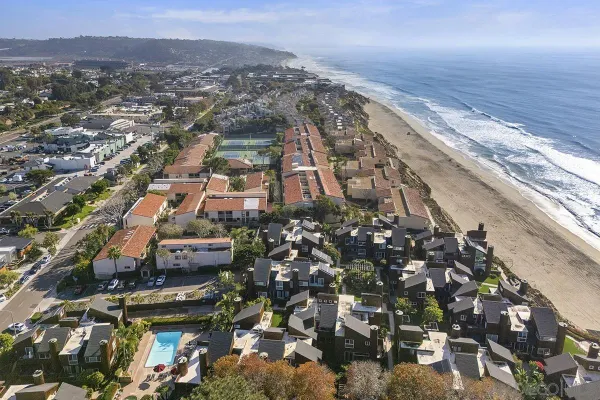 an aerial view of residential houses with city view