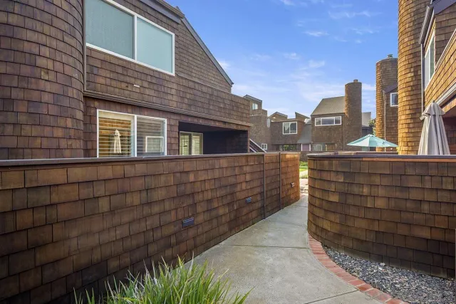 a view of a buildings with wooden fence
