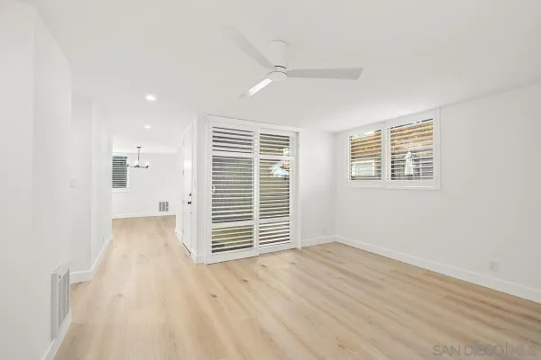 a view of wooden floor and windows in a room
