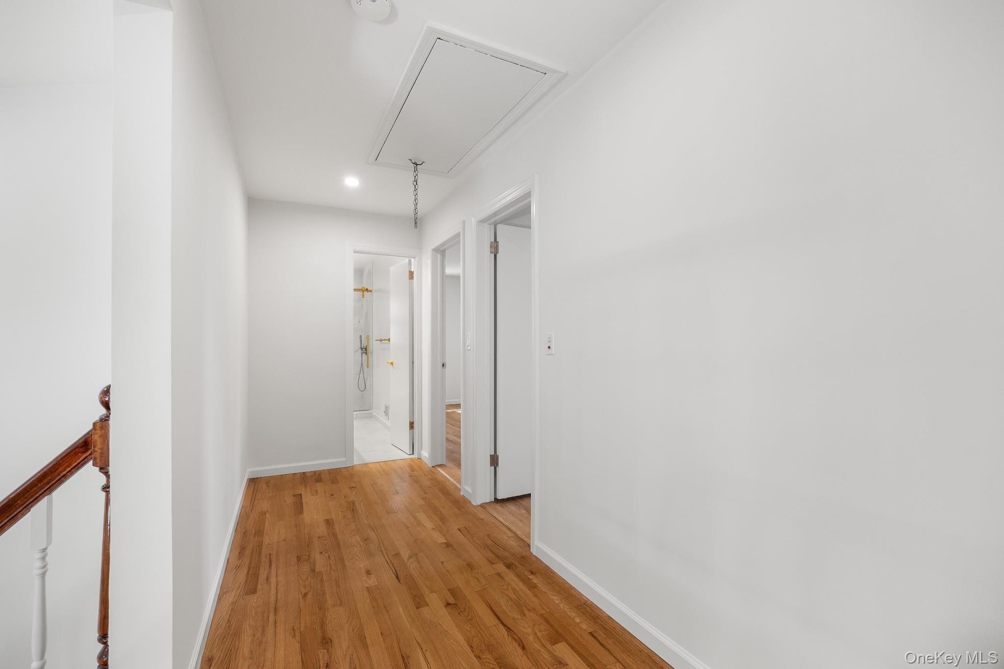 372 Heathcote Road Scarsdale, NY 10583 - Photo 16 of 20 Corridor with attic access, light wood-style floors, recessed lighting, and an upstairs landing